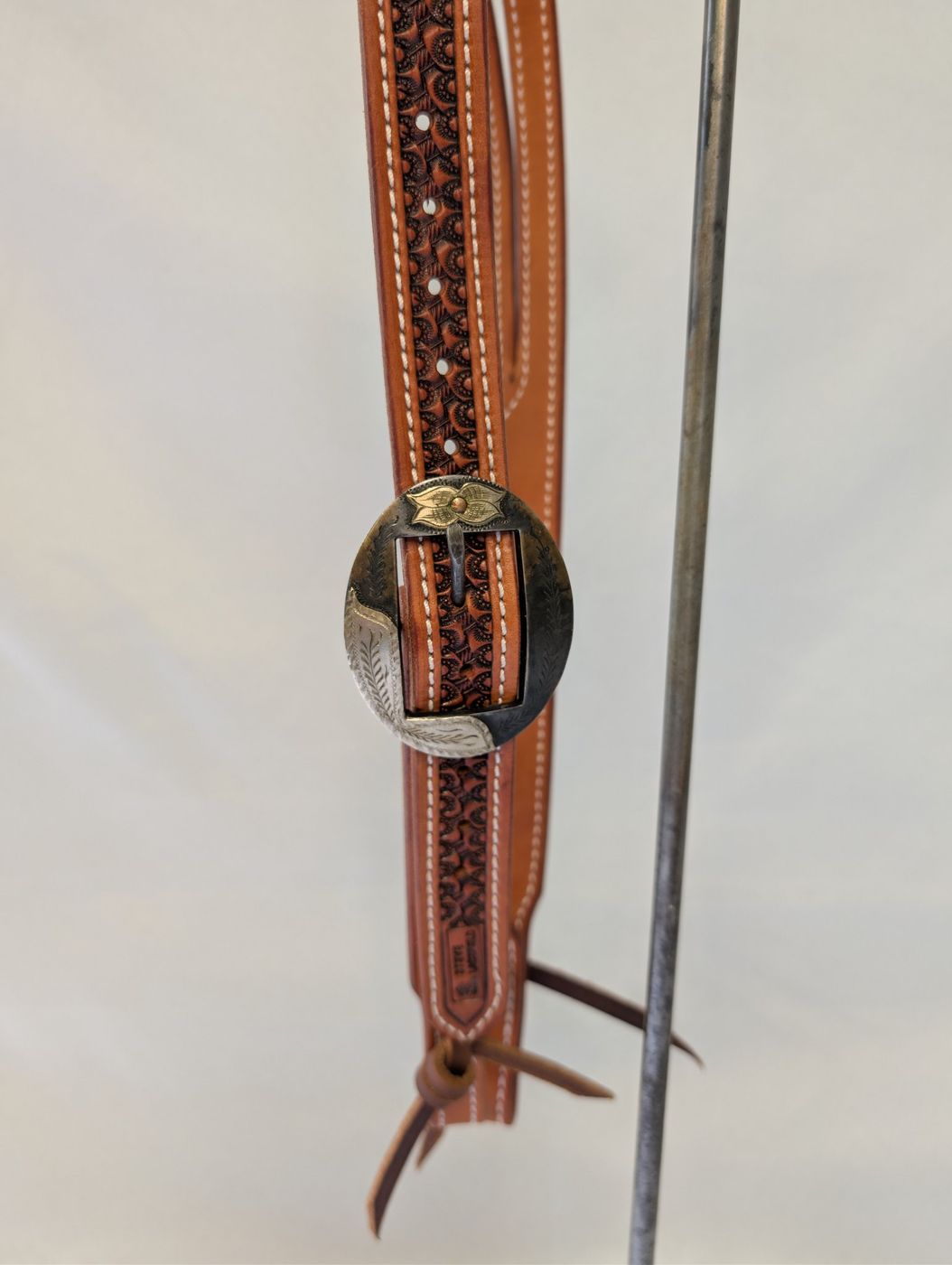 Engraved silver and black buckle close-up