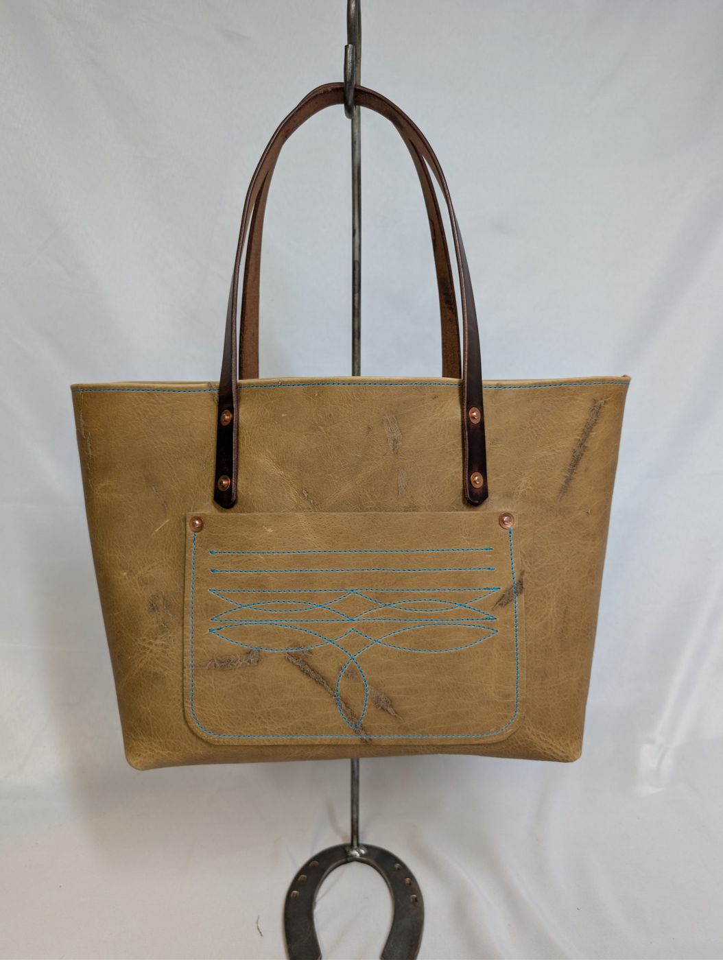 Tan leather tote with turquoise stitching
