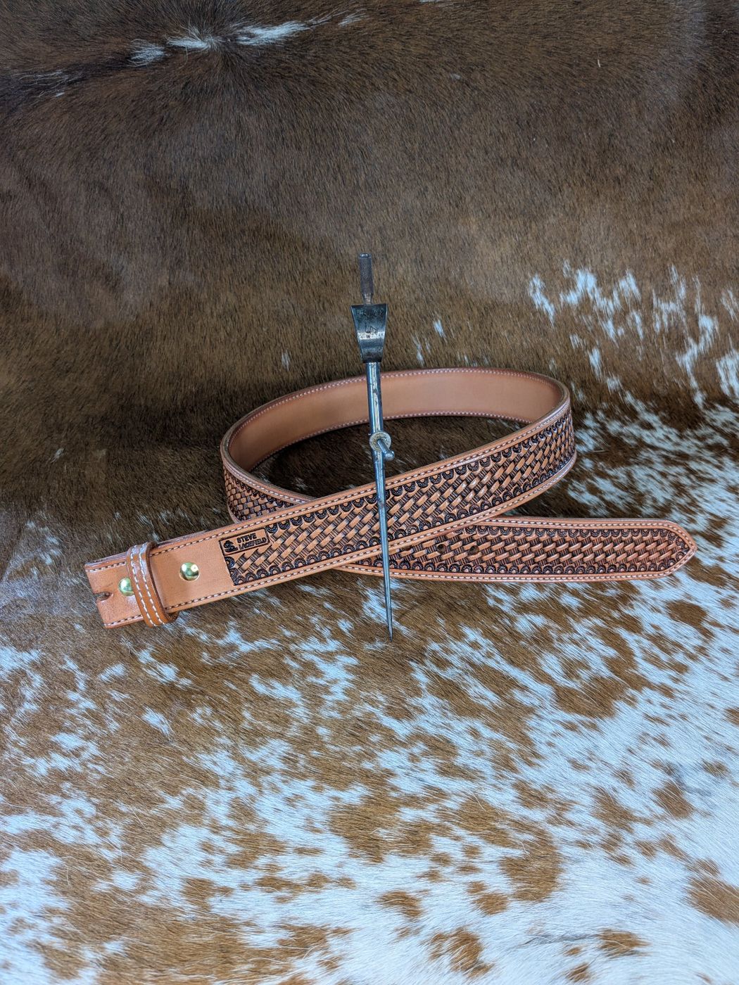 Basket-stamped leather belt on cowhide