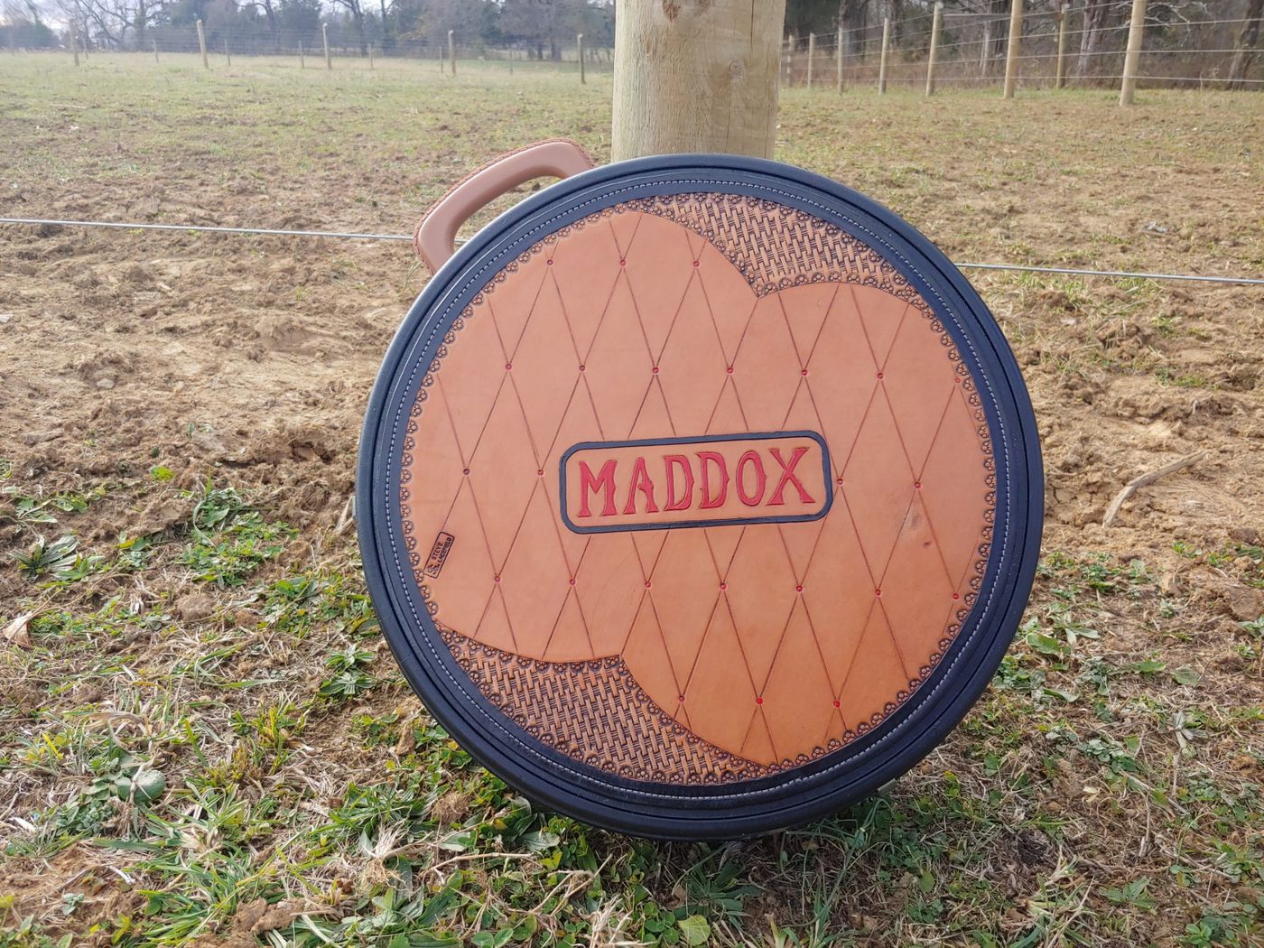 Round tooled leather case with Maddox name